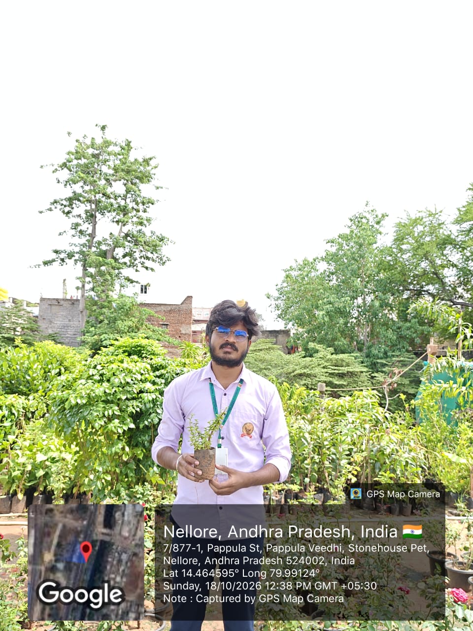 A student holding a young potted plant for the project